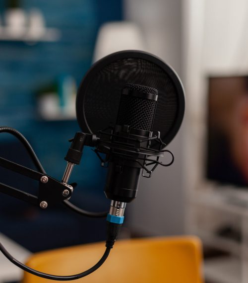 Closeup of recording microphone in home studio Closeup of recording microphone in home studio. Professional live broadcast equipment to record content on social media. Electronic audio livestream technology on desk. Podcast instrument.
